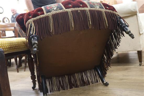 A late Victorian button back ebonised easy armchair